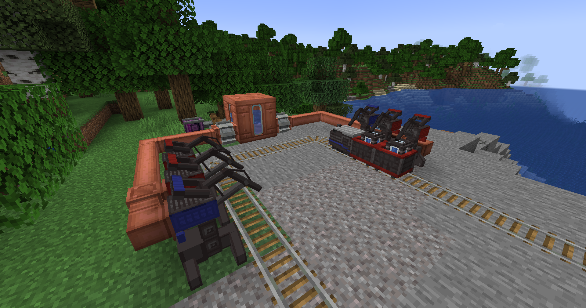 A locomotive and train cars aligned with matching coloured Docking Stations